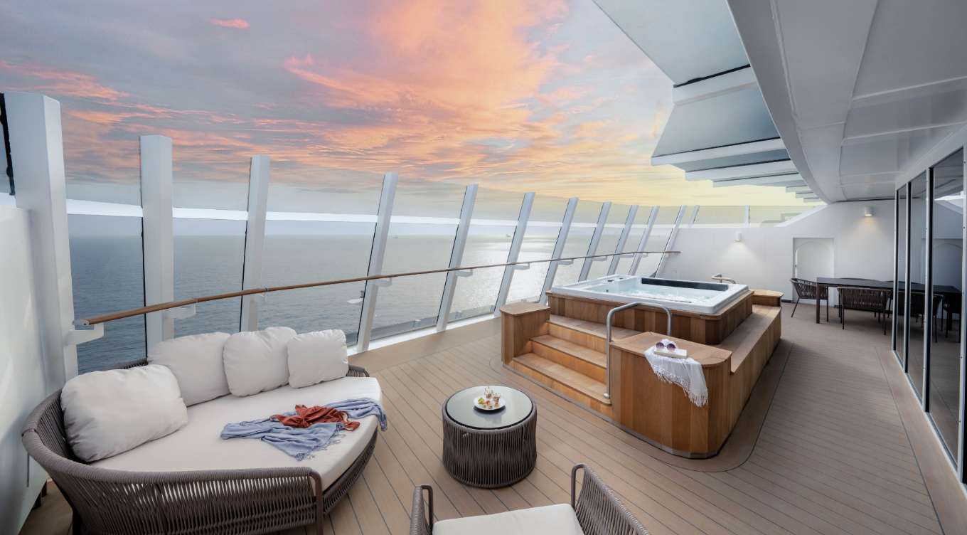 The Owner's Suite on World Europa offers opulent luxury with a spacious balcony featuring a sofa, hot tub, and breathtaking ocean and sunset views, providing the ultimate in privacy and indulgence aboard MSC Yachts