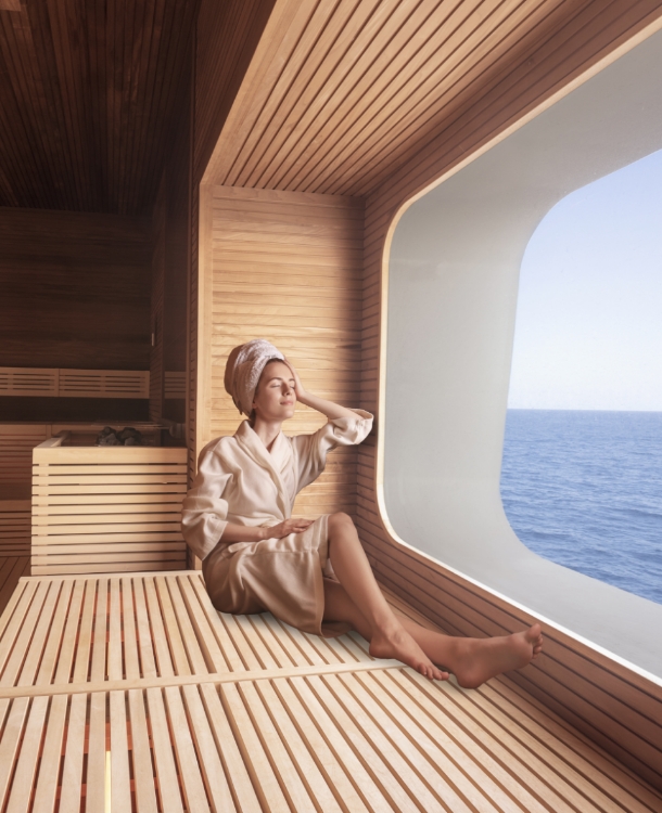 Indulge in serene spa moments on MSC Cruises, as a woman in a plush spa robe sits by a window, savoring ocean views and relaxation in the tranquil spa setting. 